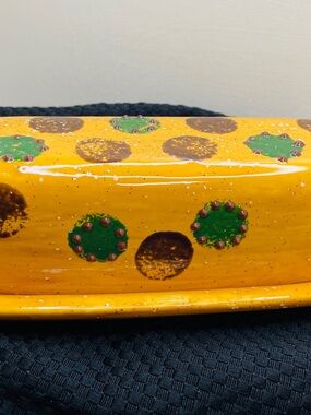 Vintage art pottery butter dish and covered jar with polka dots.